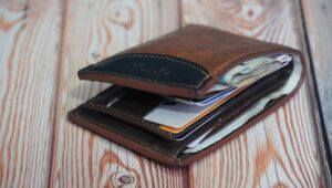 A brown leather wallet full of items