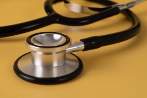 A stethoscope on a yellow table