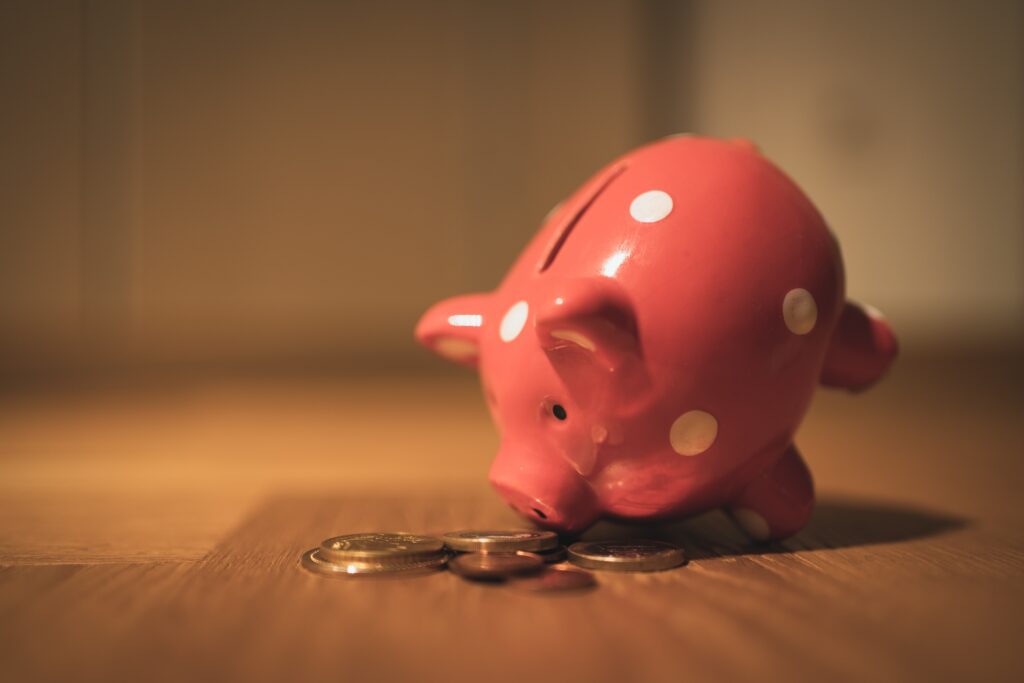 A piggy bank dips its nose in coins