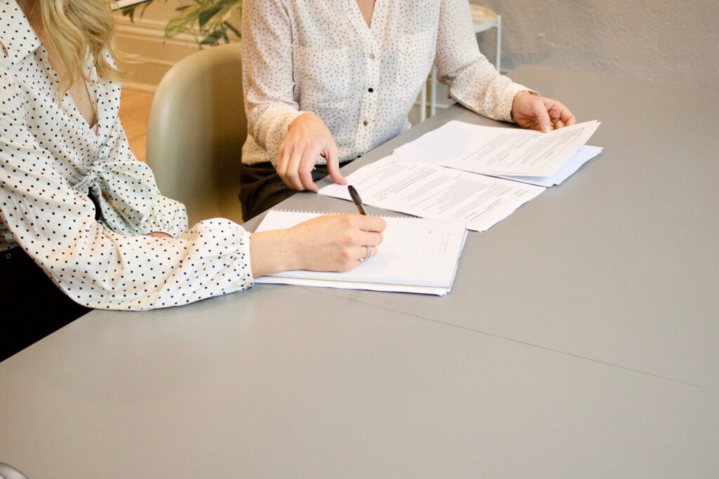 Two women discuss a contract
