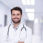 Doctor reviewing Guaranteed Standard Issue disability insurance contract avoiding medical underwriting